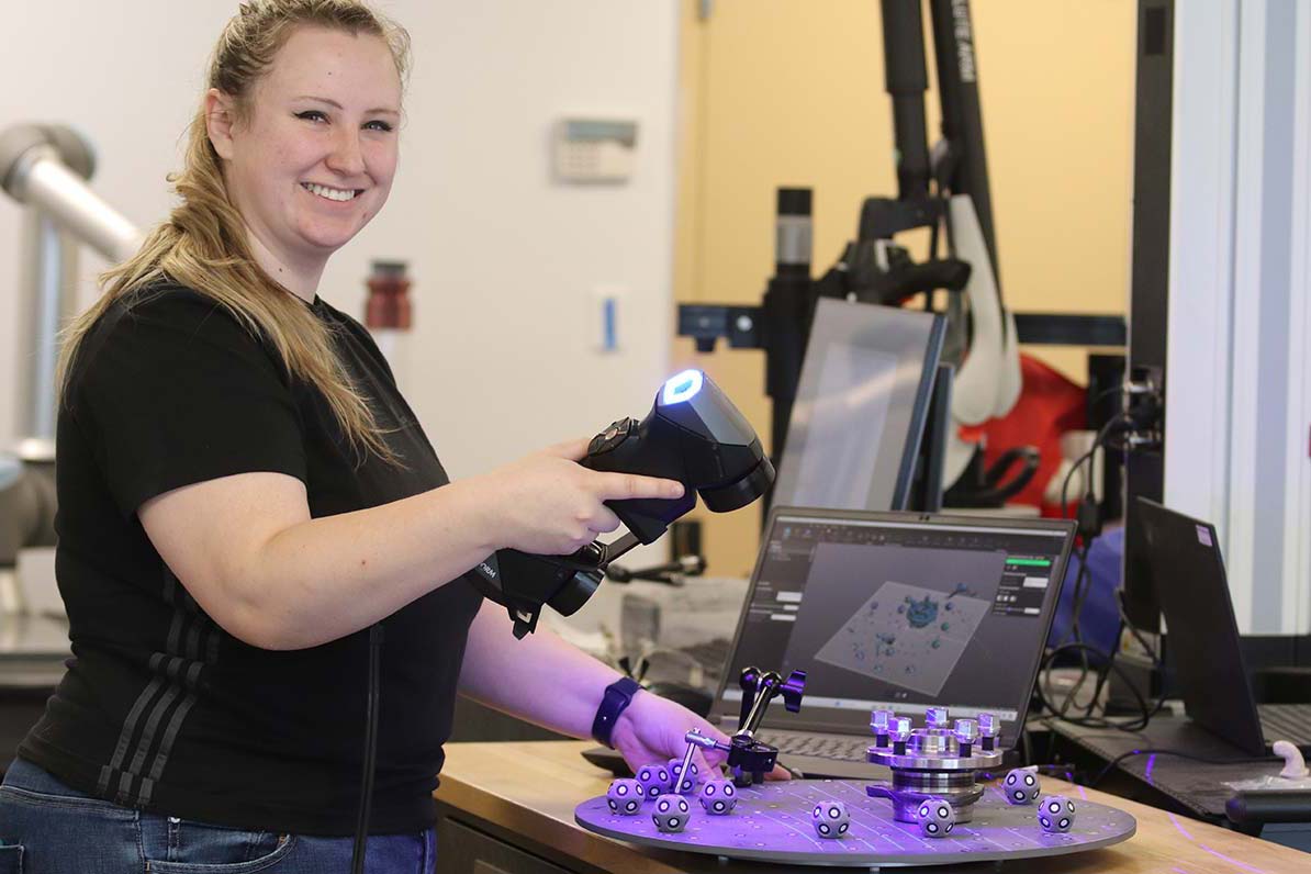 A student works with machines in advanced manufacturing