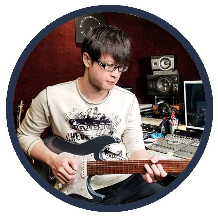 An image of graduate Kit Tang playing guitar