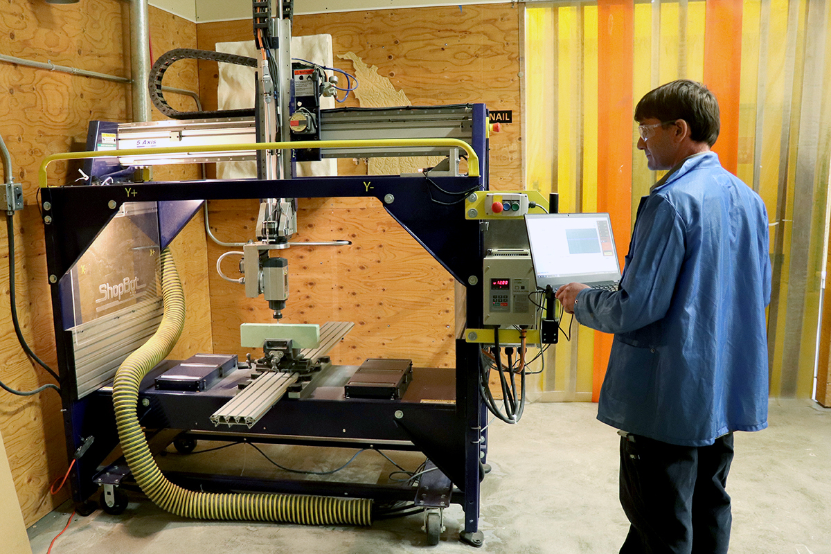 A man works with a high-tech machine