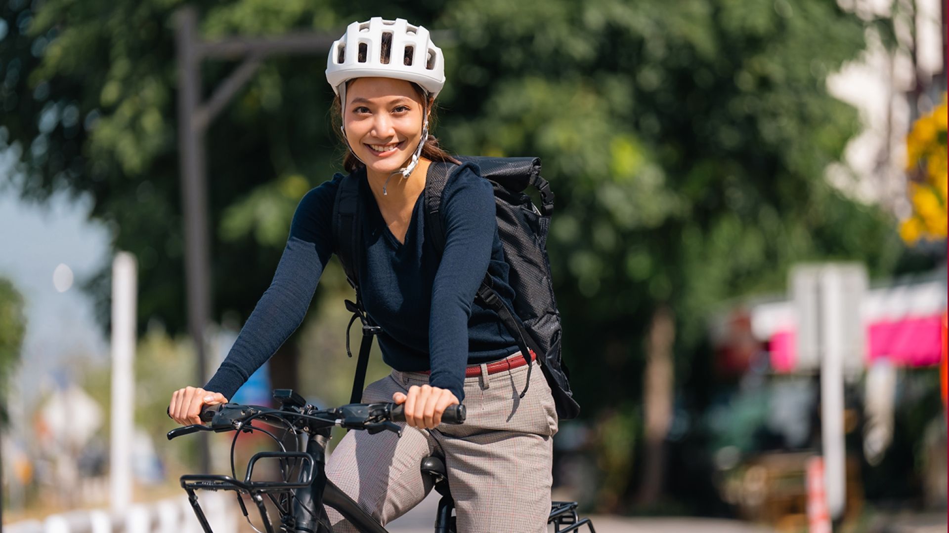 young woman riding a bike to work or school