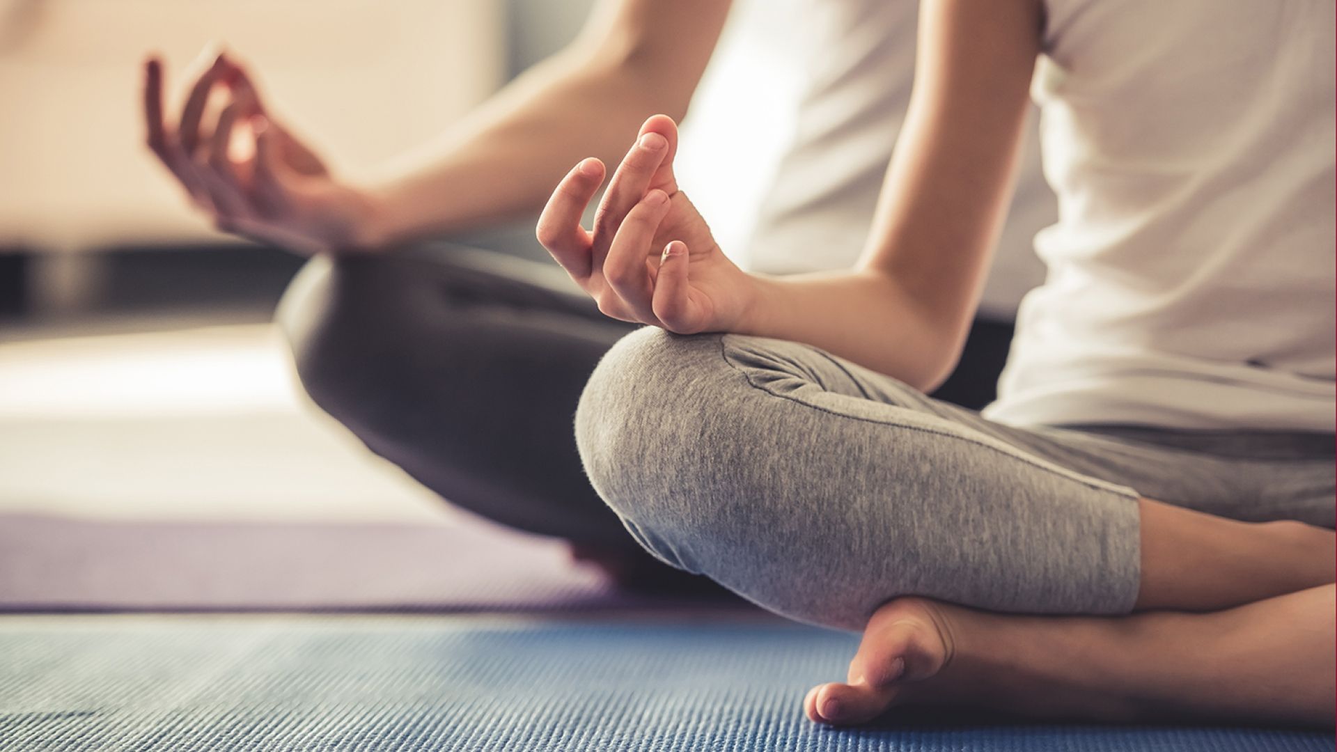 people doing seated yoga meditation on mats