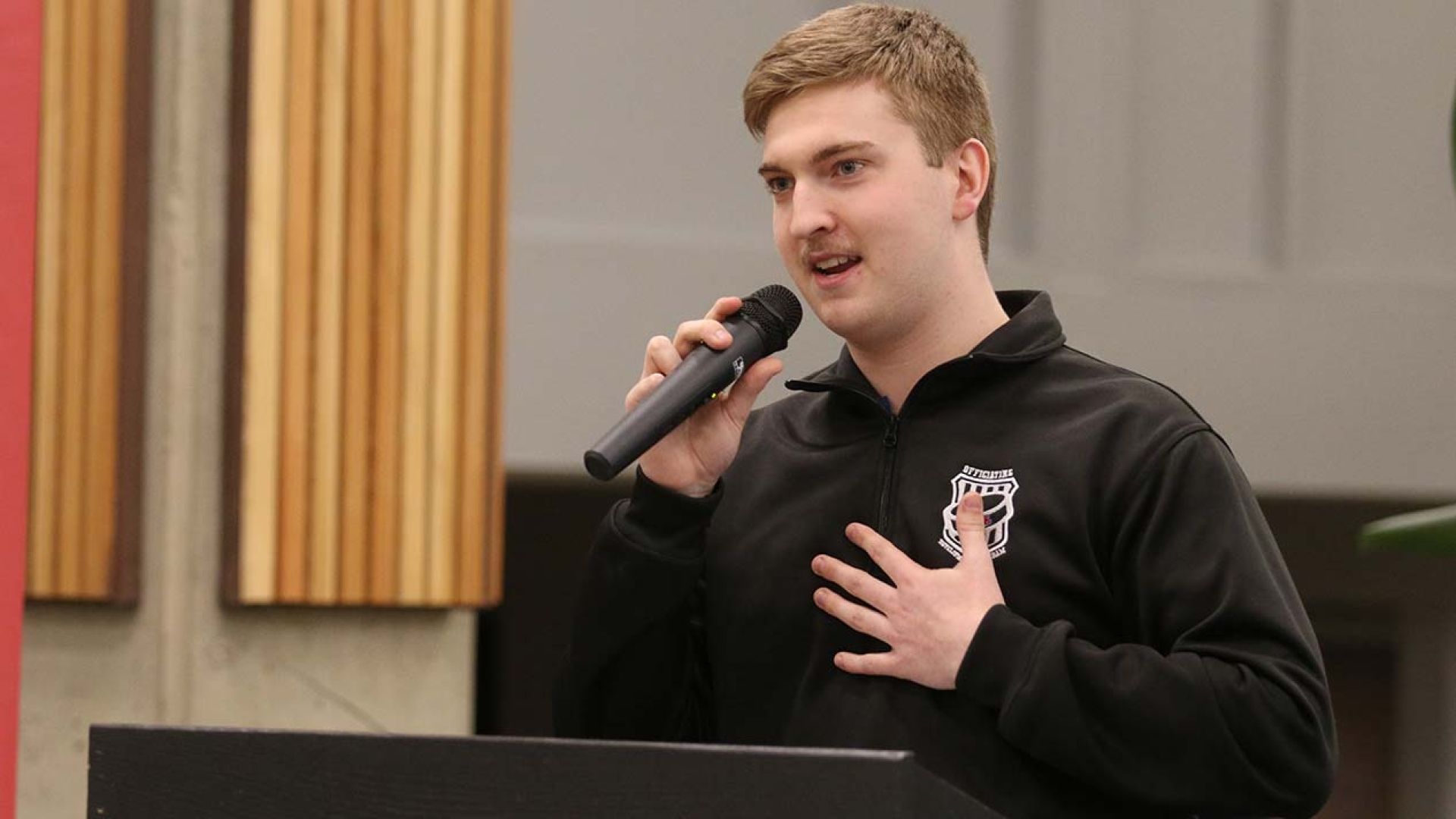Student Brady Stocks at podium at bursary event