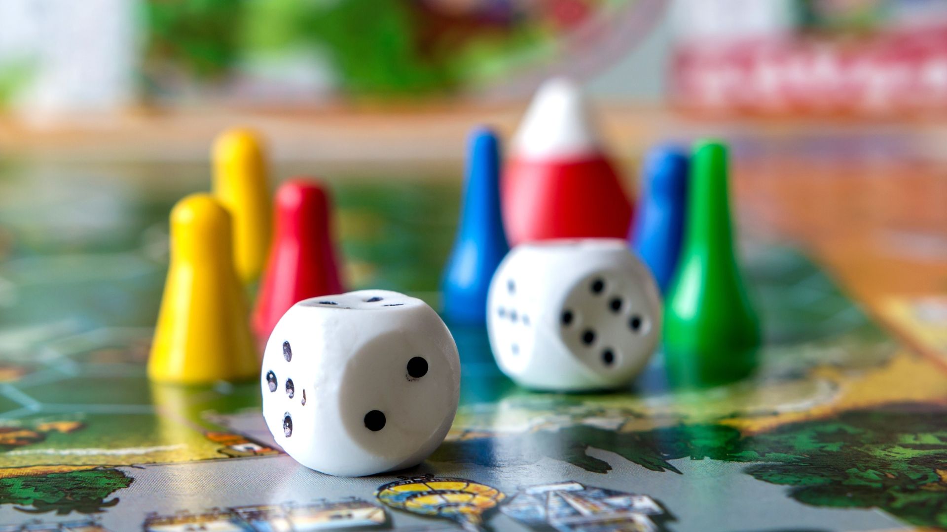 A board game with various pieces sits on a table.