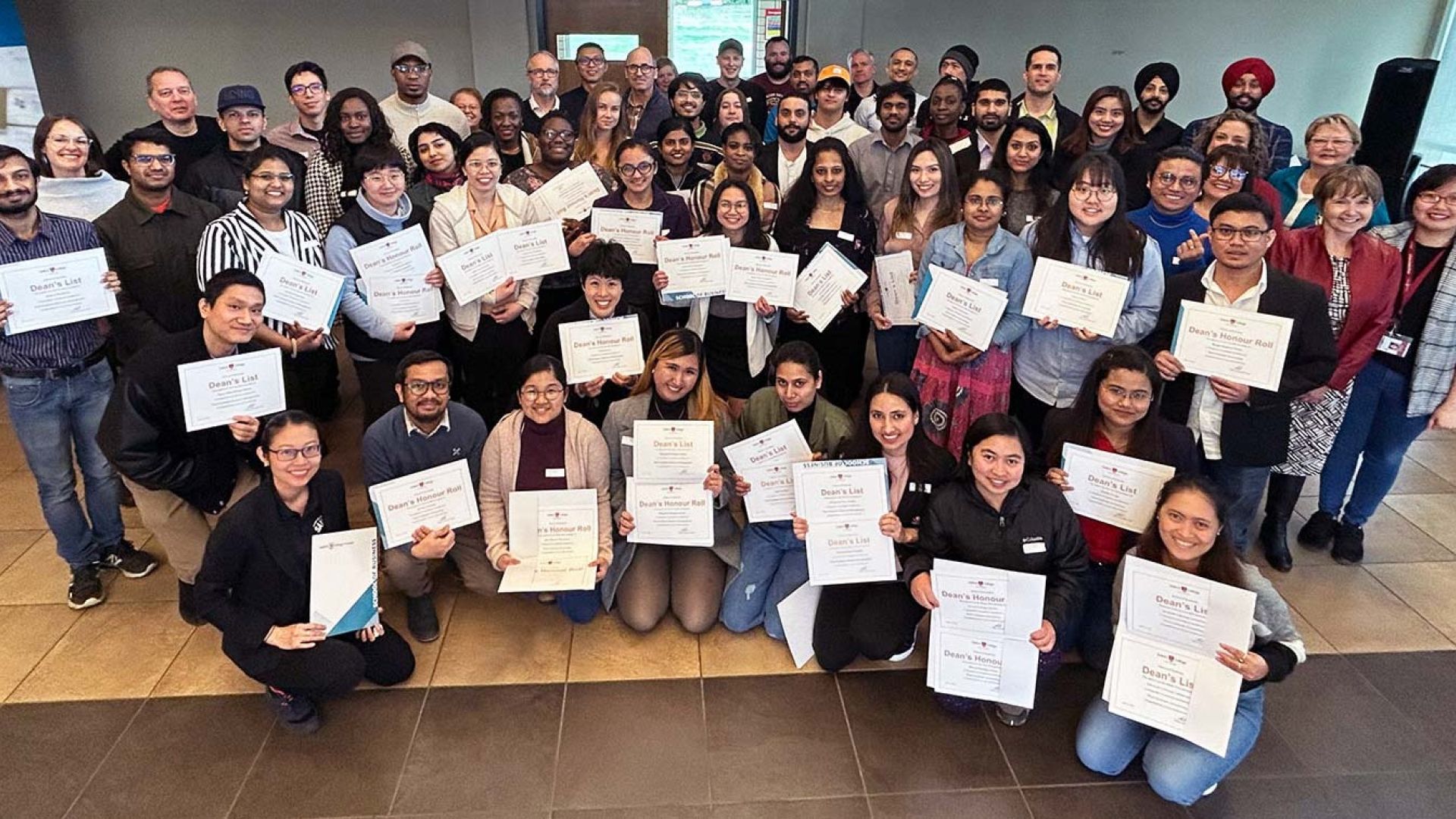 A group of students hold certificates