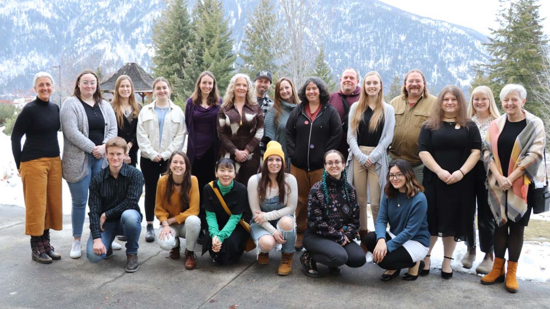 A group of people stand outside smiling