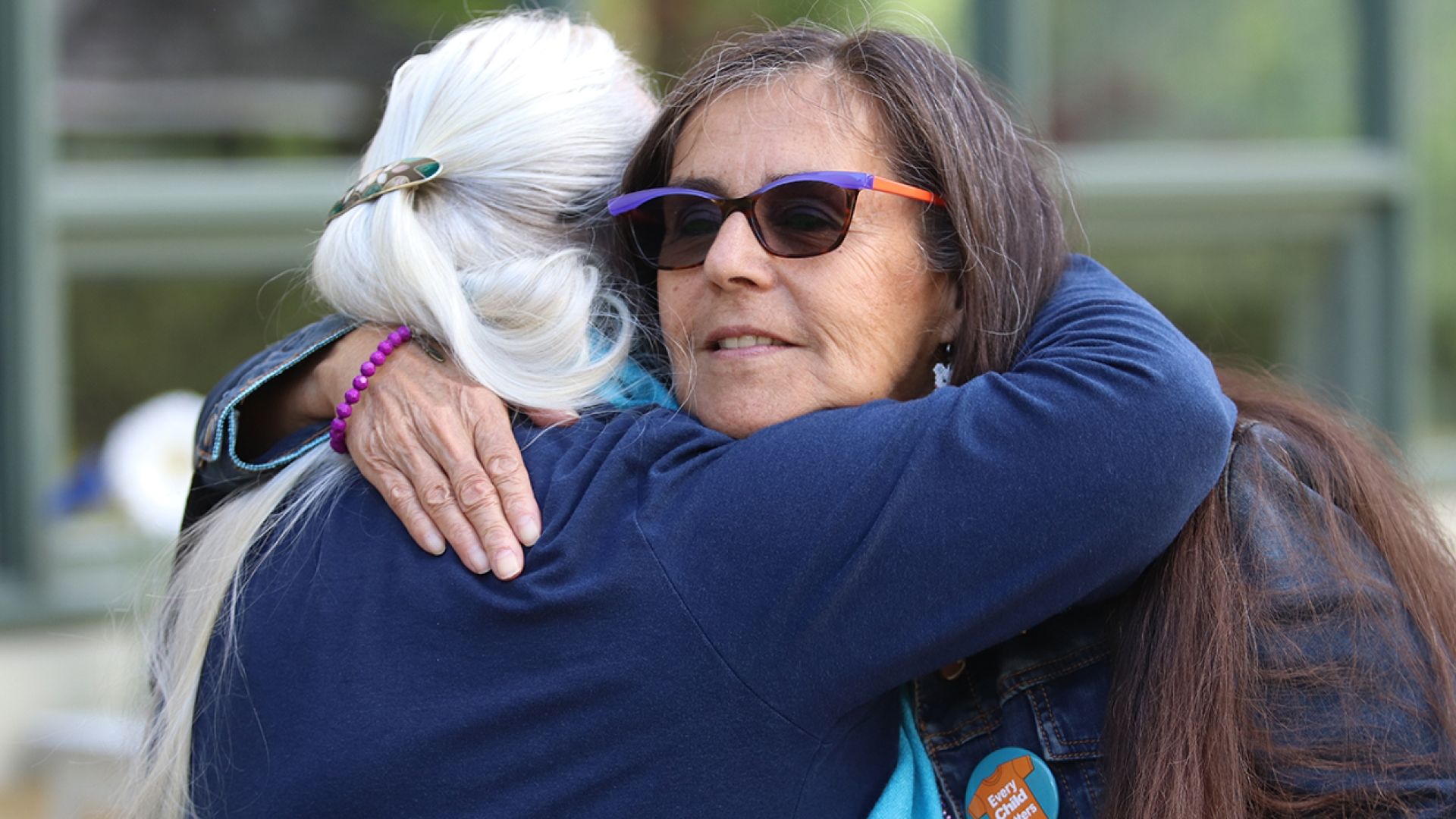 Selkirk College Board of Governors member Debbie Bird shares a hug at the Tenth Street Indigenous Gathering Space opening