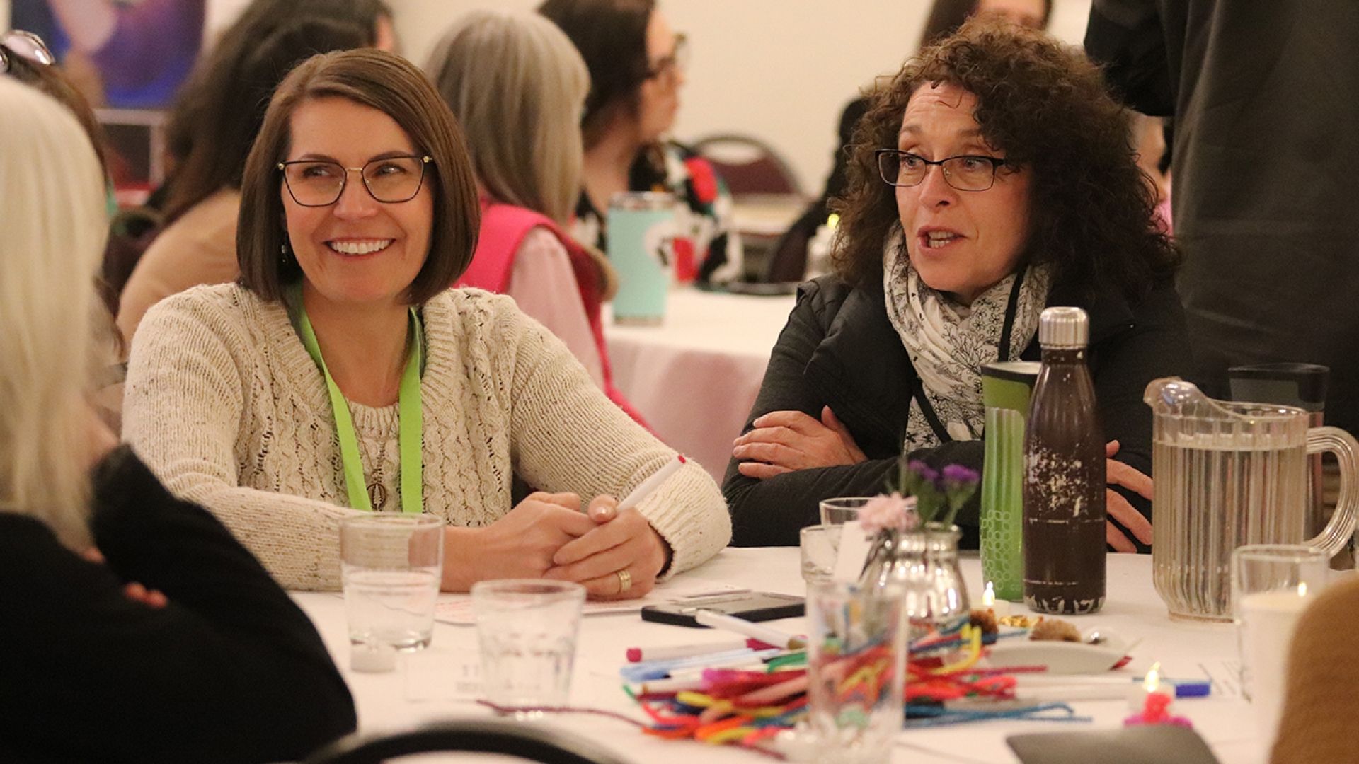 Selkirk College faculty Rhonda Belczyk and Leanna Kozak participating in a table conversation
