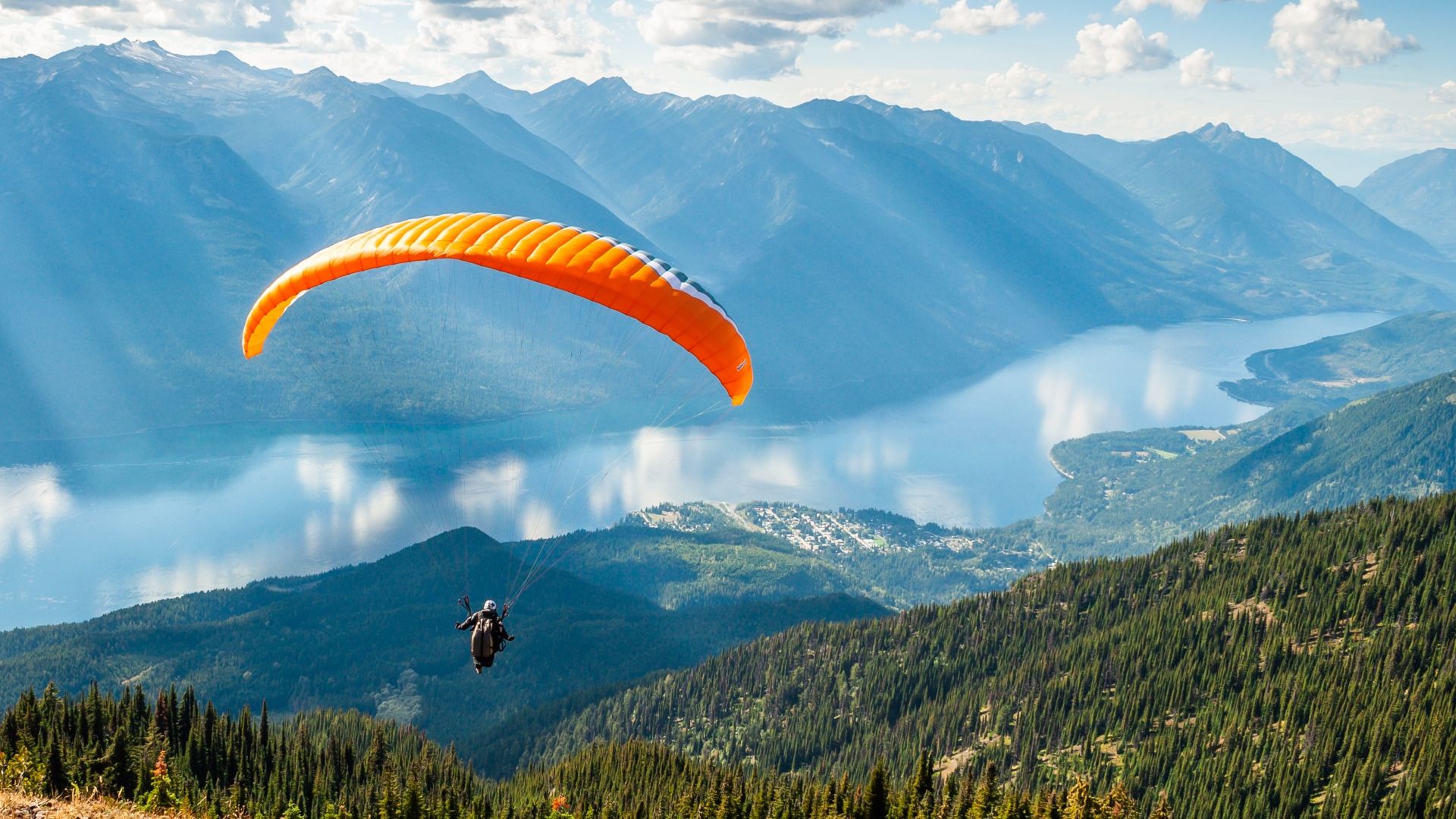 A paraglider against a mountain range