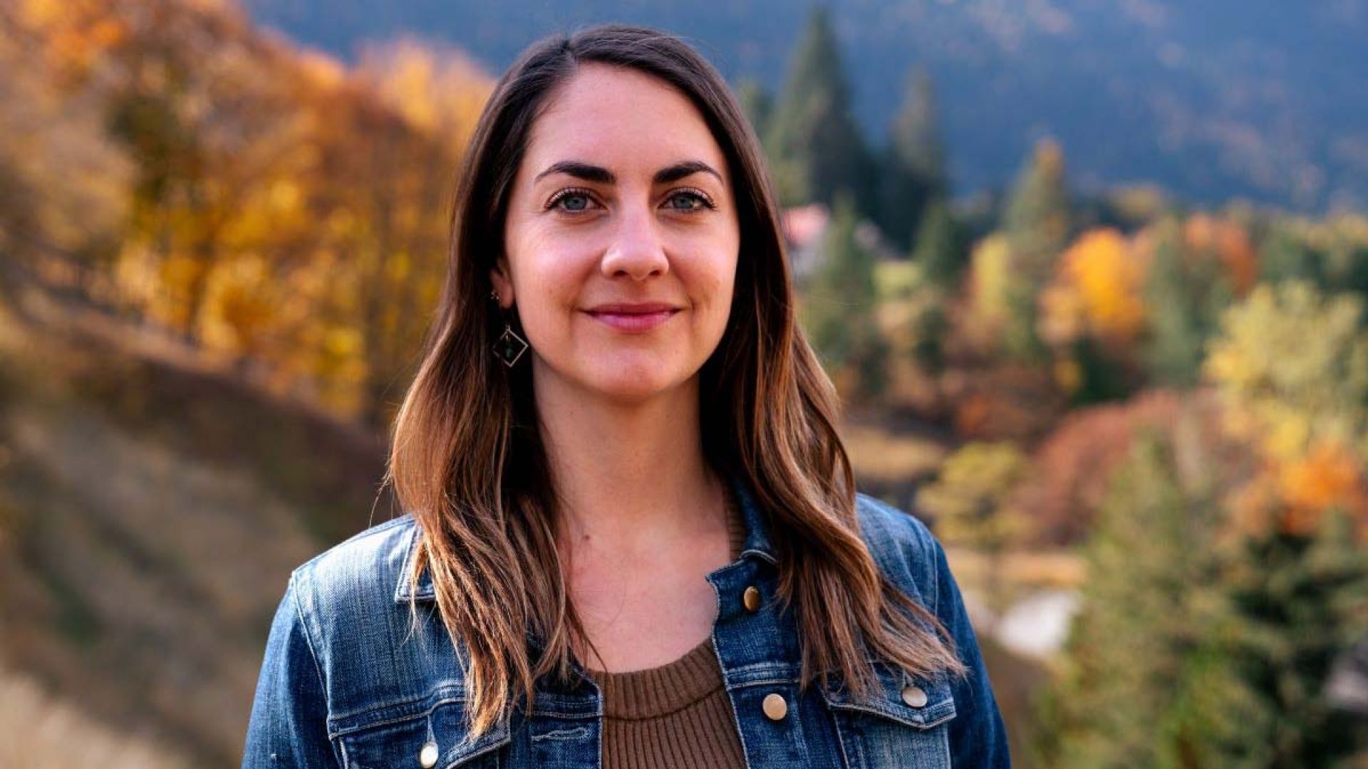 Natasha stands outside smiling