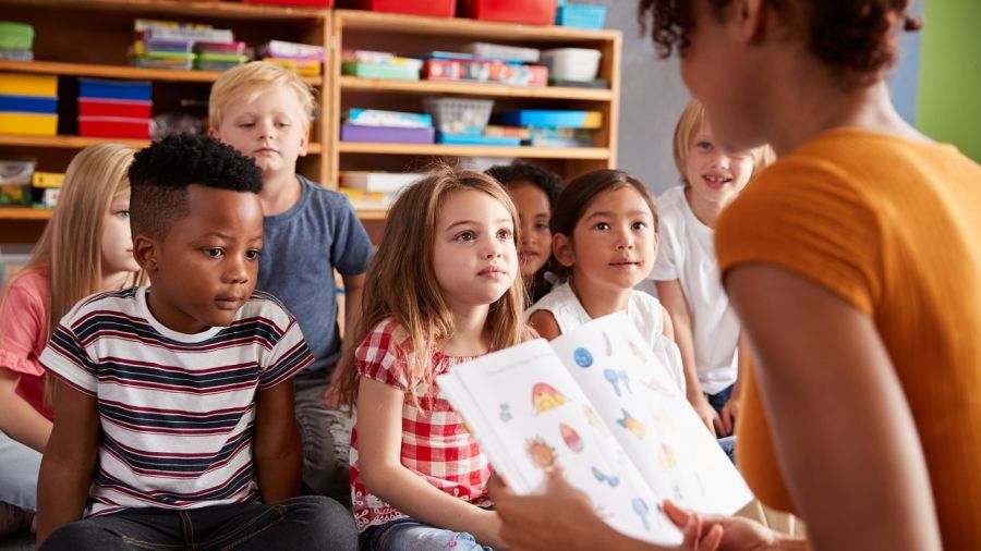 teacher-reading-school-age-children