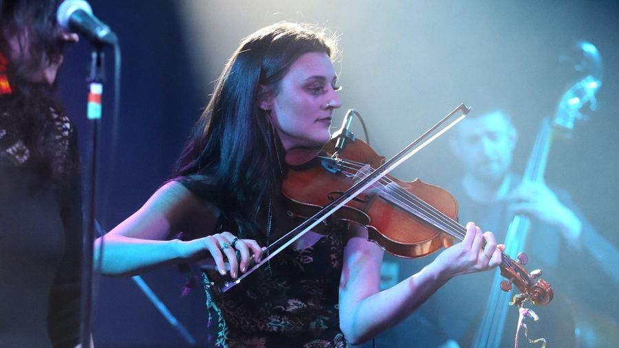 Student playing violin on stage