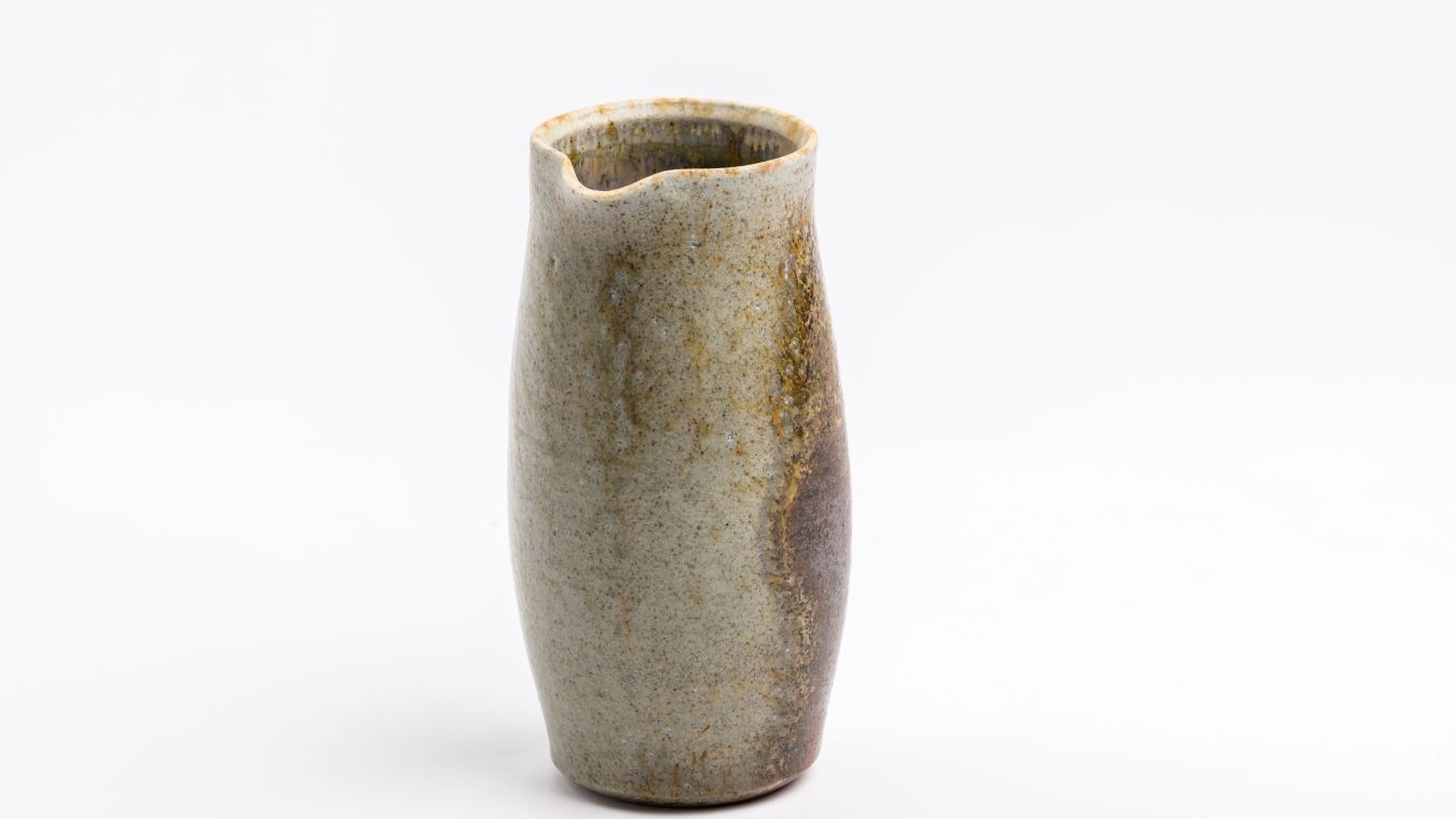 A handmade ceramic vessel in earth tones