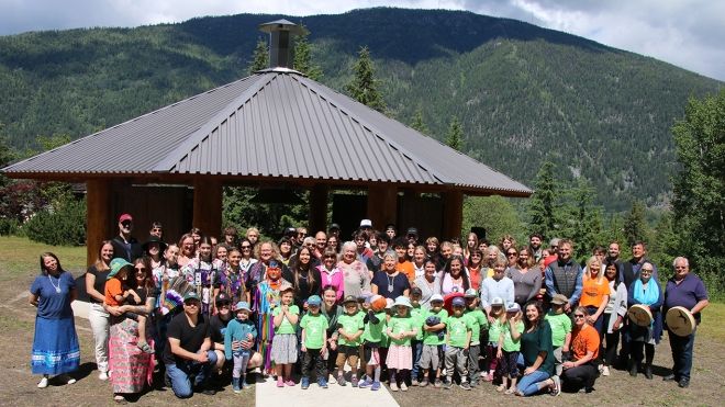 Group photo of the 80 people who attended the Tenth Street Indigenous Gathering Place opening on June 17