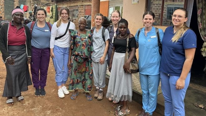 A group of people stand outside a clinic in Uganda