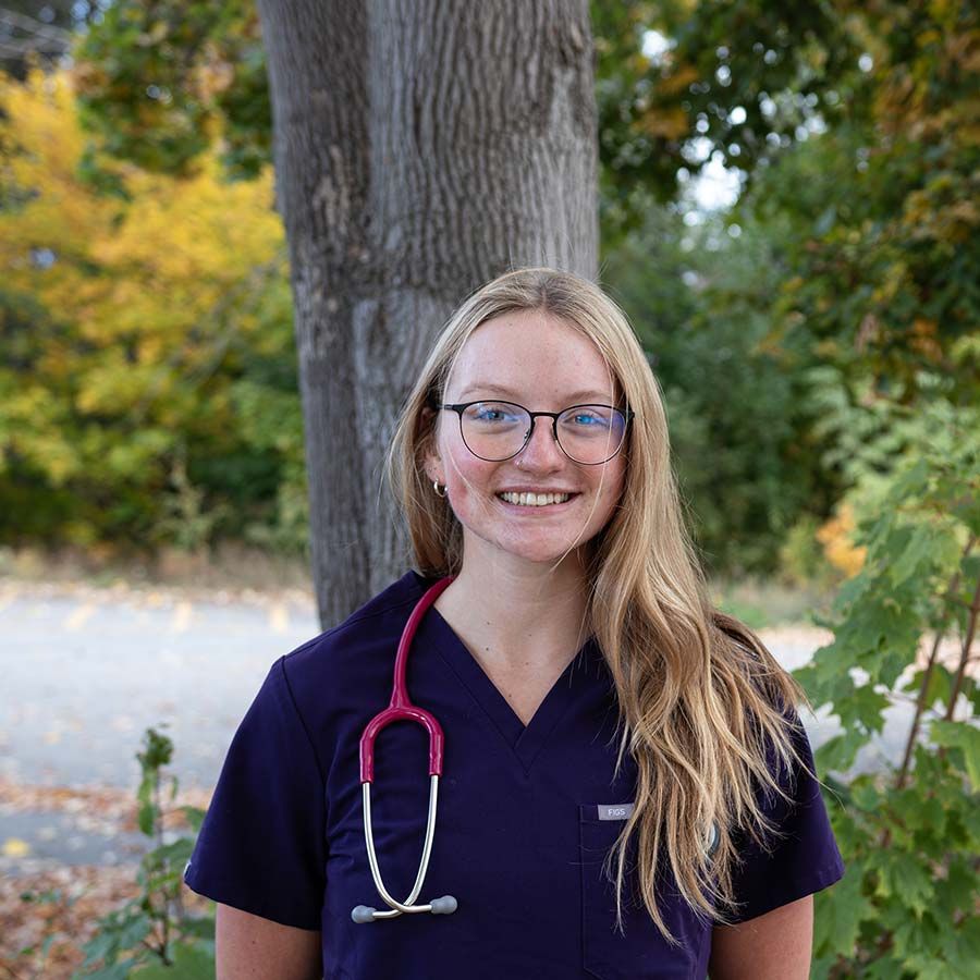 Nursing student stands outside