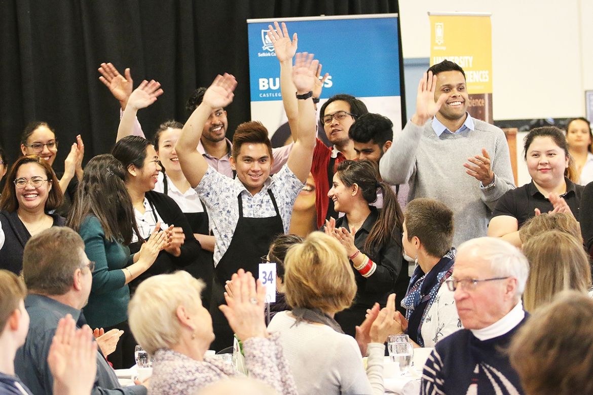 Smiling crowd of students at Bursary Tea