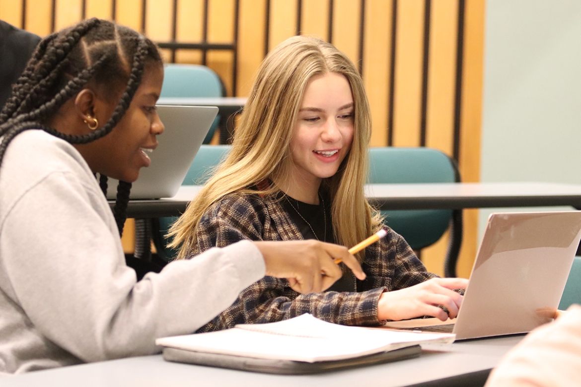 Business students looking at a laptop screen