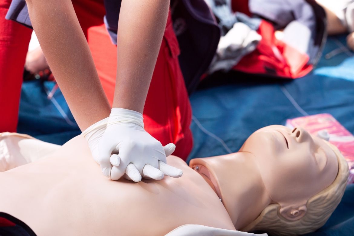Hands practice CPR on a dummy