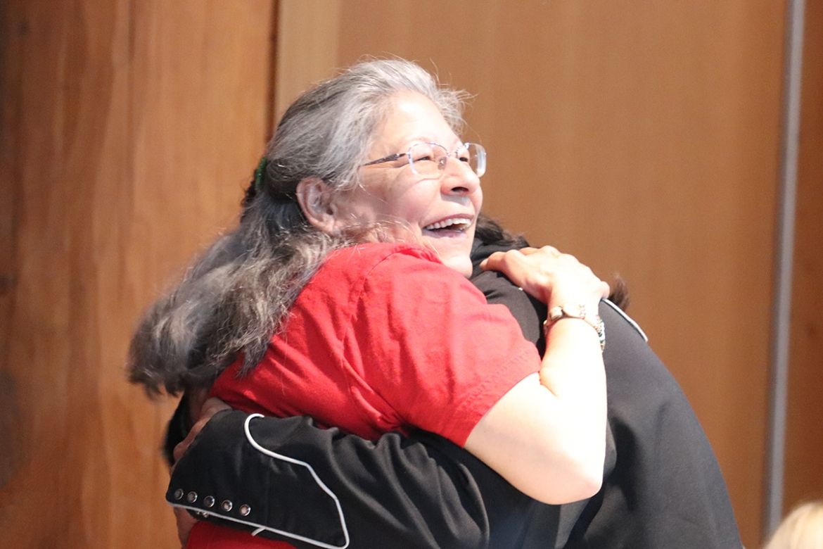 Indigenous Elders hugging at the Gathering Place