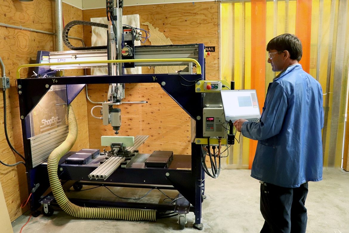 A man works with a high-tech machine