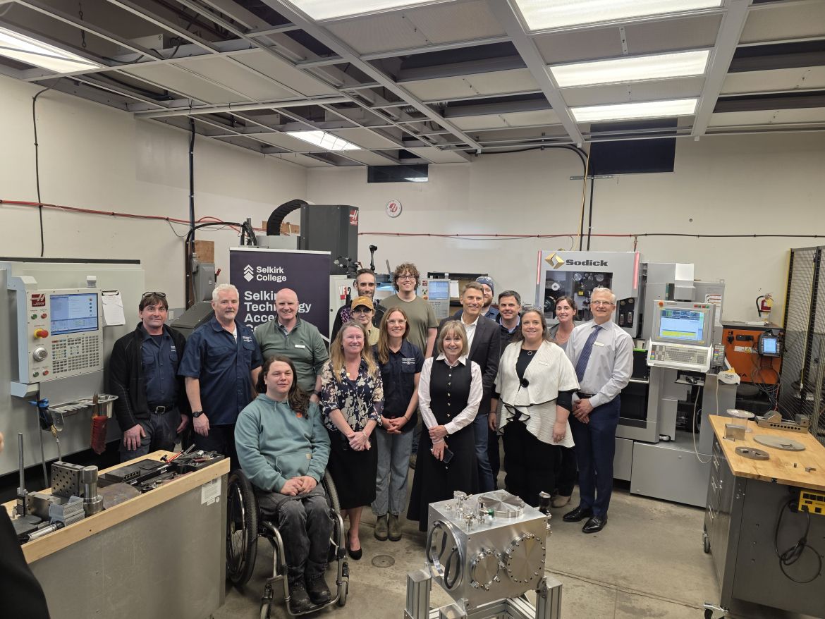 A group of employees and The Honourable Gregor Robertson stand in the STAC