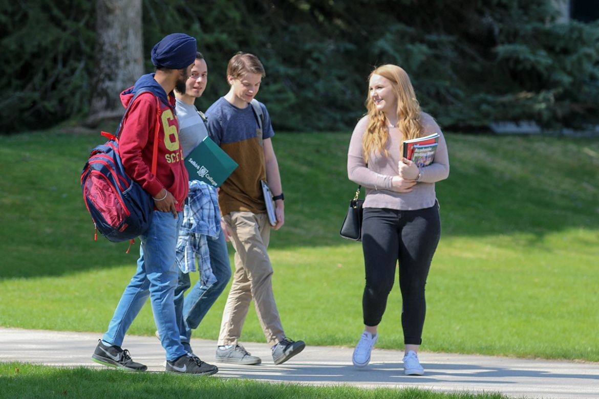 Students walking and talking on campus