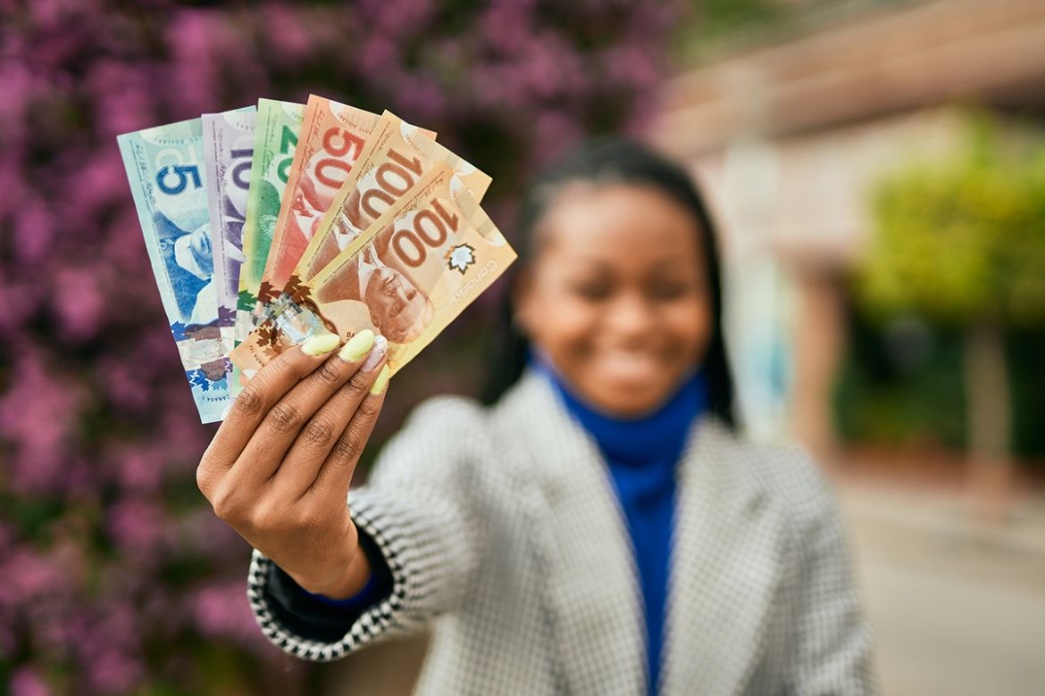 Woman holding up money