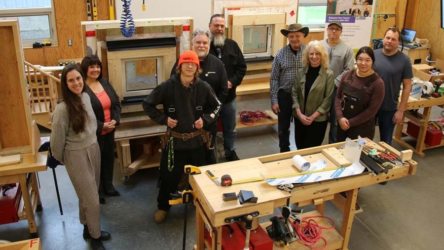 Group in carpentry shop with window project