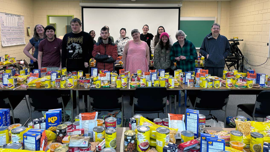 SOAR students stand surrounded by non-perishable food