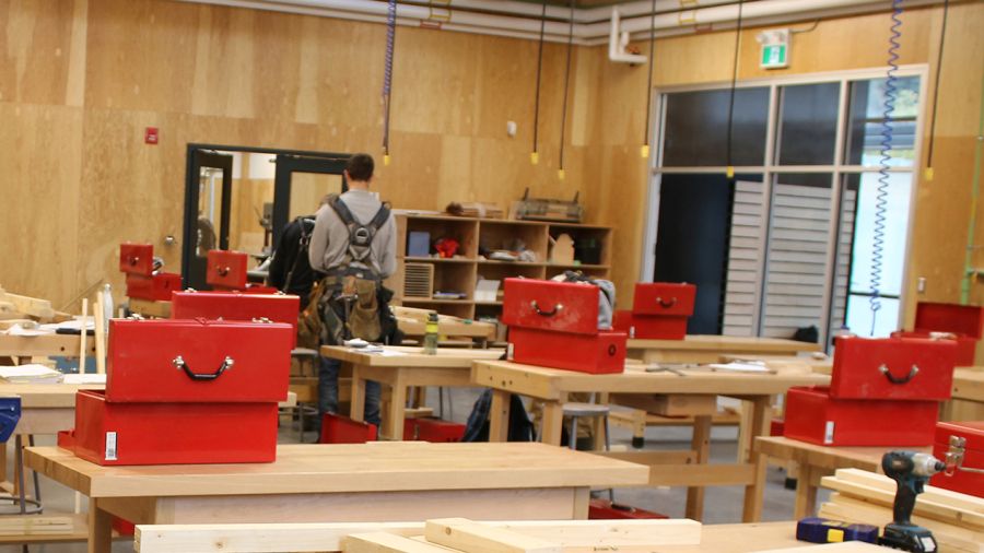 A carpentry students works in the shop