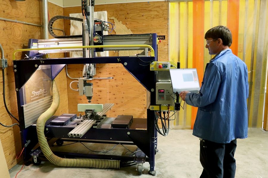 A man works with a high-tech machine