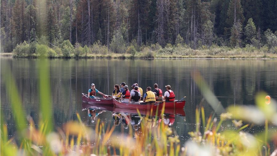 Students canoe on a lake