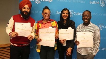 Four business students with their awards