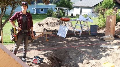 Lead carpenter Meredith Vezina stands at renovatoin project near Balfour with her tools