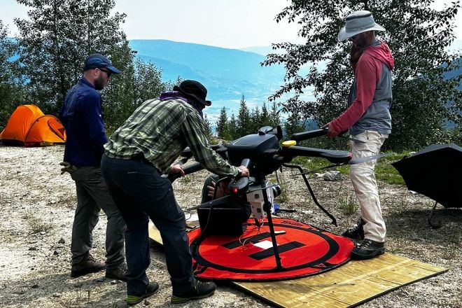 GIS team works on setting up the drone