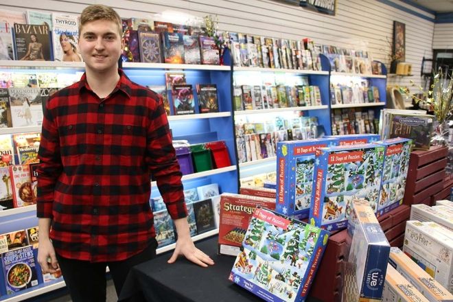 Business Adminstration Program student Brady Stocks in his shop with puzzles and magazines