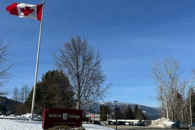 The Selkirk College Castlegar Campus sign and a Canadian flag