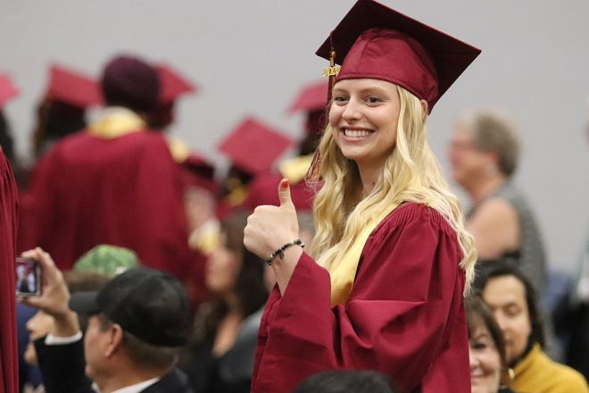 Selkirk College graduate with thumbs up
