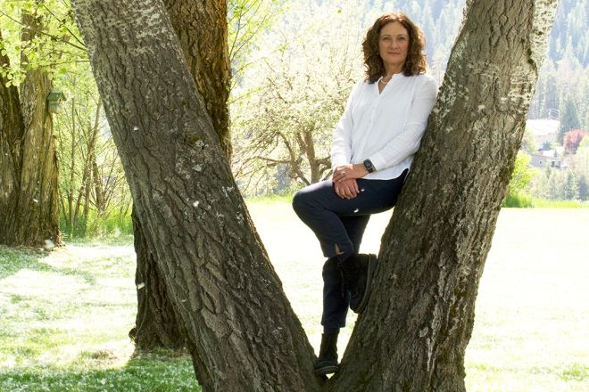 Distinguished Alumni recipient for 2024 Frances Swan stands by a tree on the Castlegar Campus