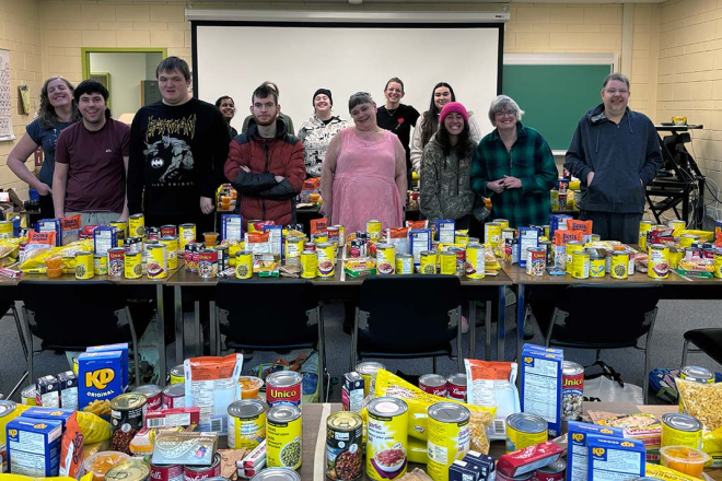 SOAR students stand surrounded by non-perishable food