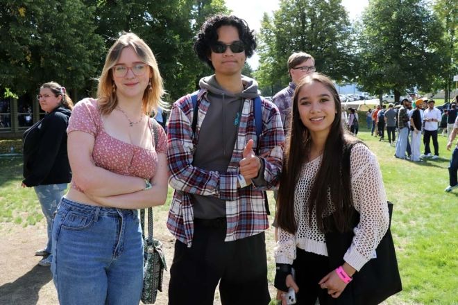 Three students stand outside at orientation