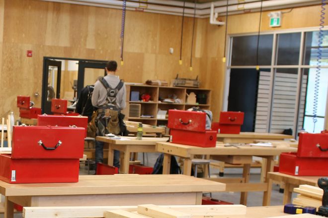 A carpentry students works in the shop