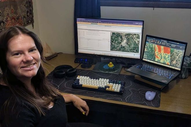 Intern Hannah Murphy sits at a desk in front of a computer 