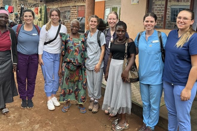 A group of people stand outside a clinic in Uganda
