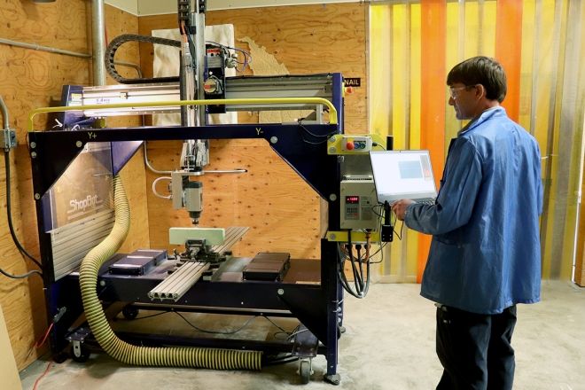 A man works with a high-tech machine