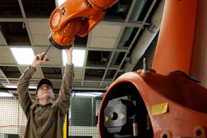 A student works with a large machine