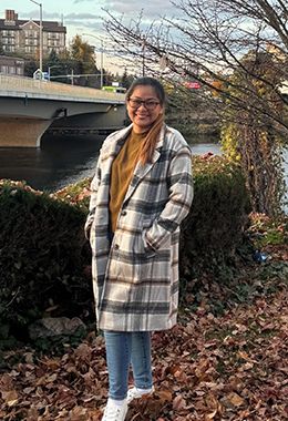 Angel Vetanilla stands outside smiling